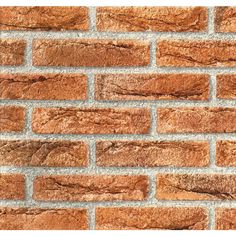 a brick wall that has been made from red bricks and is very close to the ground