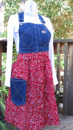 a red and blue apron dress on a mannequin with an open front pocket