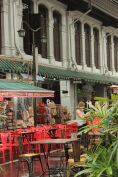 an outdoor cafe with tables and chairs in the rain