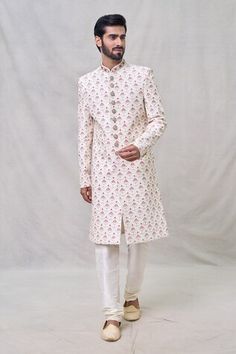 Cream sherwani with bead, cutdana, thread embroidery in lotus pattern. Paired with churidar. - Aza Fashions Fitted Floor-length Sherwani With Resham Embroidery, Embroidered Cream Chanderi Sherwani, Semi-stitched Chinon Sherwani With Intricate Embroidery, Floor-length Resham Embroidered Sherwani, Embroidered Off-white Chanderi Sherwani, Men Cream, Beaded Neckline, Churidar, Silk Embroidery