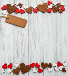 wooden hearts and a tag on a white wood background