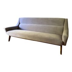 a gray couch sitting on top of a wooden frame