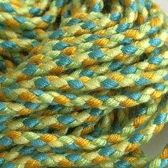 a close up of a rope with blue, yellow and green colors