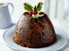 a christmas pudding on a plate with holly decorations