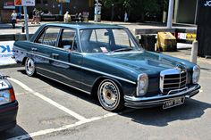 an old mercedes parked in a parking lot