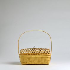 a yellow basket sitting on top of a white table