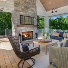 a living room with furniture and a fire place in the middle of an outdoor area