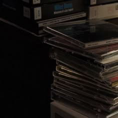 a stack of cd's sitting on top of a table next to each other