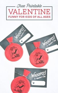 two red frisbees with tags attached to them that say whoopel