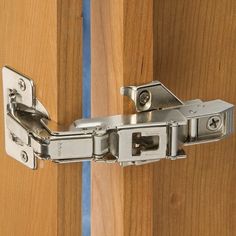 a close up view of a wooden door hinge with metal latches on it