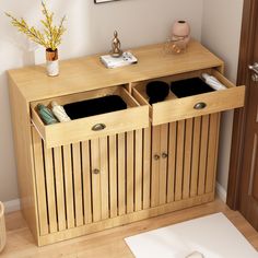 a wooden cabinet with two bins on top of it next to a white rug