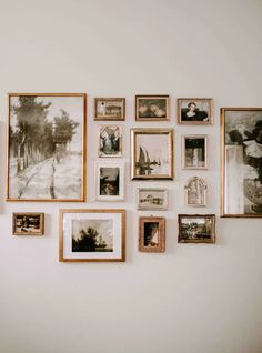 a wall with many pictures hanging on it