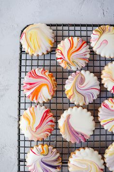 some colorful cookies are on a cooling rack