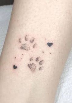 a small paw print with hearts on it