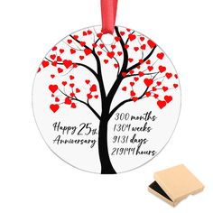 an ornament with a tree and hearts on it, next to a rubber stamp