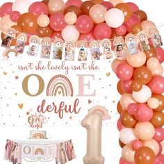 the balloon arch is decorated with photos and balloons for an onederful first birthday party