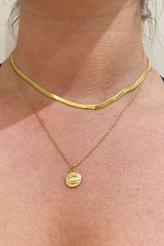 A woman wearing gold layered necklaces. Trendy Choker Chain Necklace, Trendy Double Chain Choker Necklace, Trendy Snake Chain Choker, Trendy Clavicle Chain Choker For Layering, Trendy Tarnish-resistant Choker Necklace, Metal Figaro Chain Choker Necklace, Trendy Double Chain Choker As Gift, Trendy Choker With Double Chain For Gift, Trendy Gift Choker With Double Chain