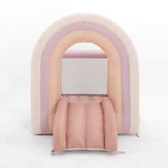 an inflatable bed with a pink and white pillow on it's side