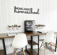 a desk with two chairs next to it and a sign that says home sweet homeschool