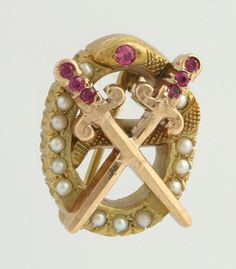 an antique brooch with two crosses and pearls