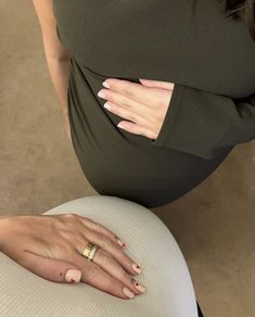 a woman's hand on top of her pregnant belly