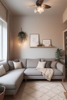 a living room filled with furniture and a large white sectional couch in front of a window