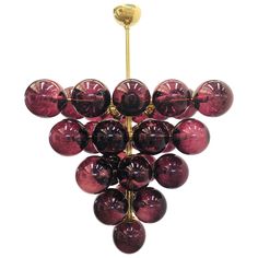 a chandelier made out of red glass balls