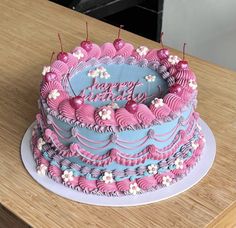 a birthday cake with pink and blue frosting