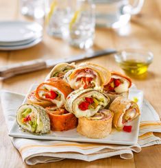 a white plate topped with rolls covered in veggies