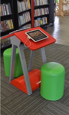 a small table with an ipad on it in a library