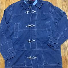 Vintage Denim Tommy Firefighter Jacket Used Good Condition. Urban Blue Outerwear With Button Closure, Denim Blue Utility Outerwear, Fall Utility Denim Blue Outerwear, Denim Blue Cotton Utility Outerwear, Utility Style Cotton Denim Blue Outerwear, Utility Style Cotton Outerwear In Denim Blue, Casual Dark Wash Outerwear For Outdoor, Blue Utility Outerwear With Pockets, Tommy Hilfiger Fall Outerwear With Pockets