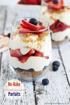 no bake cheesecake parfaits in a glass with strawberries and blueberries