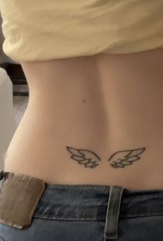 a woman's stomach with two wings on it