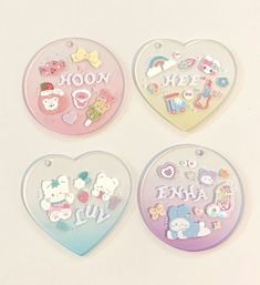 three heart shaped magnets with hello kitty designs on the front and back of them