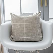 a white chair with a pillow on top of it