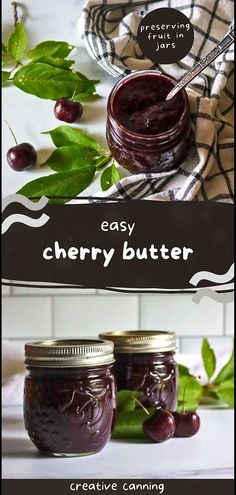 two jars filled with cherry butter sitting on top of a table next to green leaves