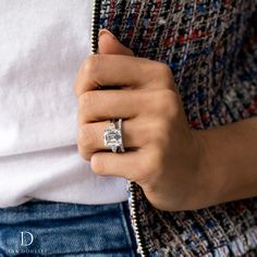 a woman wearing a diamond ring and jacket