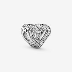 Carry your love with you as you go with this sterling silver Sparkling Freehand Heart Charm, designed to represent perfectly imperfect love. Who does the freehand heart bring to mind for you? 50 brilliant-cut clear cubic zirconia make love sparkle and cut-outs around the edges resemble “xoxo”. This charm is the perfect way to show the world what a gift the love in your life is. Style it with your other favorite Pandora charms. - Pandora Sparkling Freehand Heart Charm - Sterling silver / Cubic Zirconia / Clear Charms Pandora, Bracelet Pandora, Pave Beads, Precious Gift, Pandora Charm, Popular Jewelry, Love Charms, Bracelet Collection, Dangle Charms