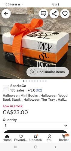 a box with an orange ribbon tied around it and the words trick or treat on top