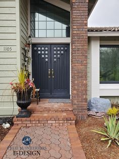 the front entrance to a home with two large doors and brick steps leading up to it