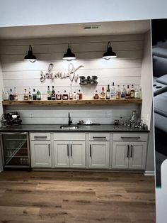 a kitchen with white cabinets and wooden floors is shown in this split screen shot from the inside