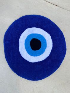 a blue and white rug with an evil eye on it