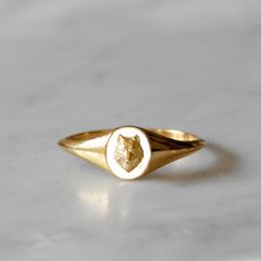 This Wolf mini signet ring has a striking three dimensional quality to it.  The elegant oval face of the ring features a Wolf’s head soldered on top - The Wolf as a spirit animal symbolises intelligence, strong instincts, an appetite for freedom and loyalty to their pack.    Effortlessly stylish, looks great worn as a pinky ring or on other fingers for a minimalist look   Made from recycled solid 9ct yellow gold.  Handmade in our No 13 Jewellery studio in Hatton Garden, London from 100% recycled Jewellery Studio, Gold Pinky Ring, Wolf Ring, Leaf Engagement Ring, Diamond Cluster Engagement Ring, Black Diamond Engagement, Oval Face, Black Diamond Ring Engagement, Gold Signet Ring