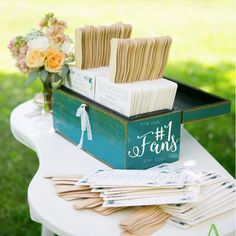 a table topped with lots of cards on top of a white table covered in flowers