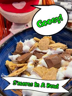 a bowl filled with cereal and marshmallows on top of a blue plate