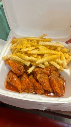 chicken wings and french fries in a styrofoam container