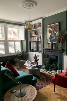 a living room filled with furniture and a fire place in the middle of a room