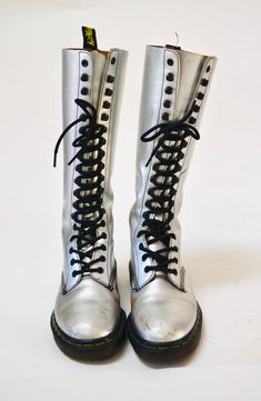 "Made in England by Dr. Martens Made in England by Dr. Martens Silver metallic leather Print Combat boots Size -VTG Size 4 UK US Womens aprx 6 Leather upper Rubber souls 10 3/8\" length outer sole 9 1/8\" length inner sole 4\" width outer sole 3 3/4\" width inner sole Shaft Height 12 1/2\" from heel Used Vintage condition with below points * wear/scuffs on outside of shoe where the silver has worn * Some wear on the inside of the insoles * Some wear on the soles * Lots of life in them! Price is Trendy Knee-high Moto Boots, Trendy Fitted Knee-high Moto Boots, Spring Leather Knee-high Combat Boots, Knee-high Combat Boots For Fall, Fitted Knee-high Leather Combat Boots, Fitted Leather Knee-high Combat Boots, Leather Knee-high Boots With Lacing, Trendy Fitted Knee-high Lace-up Boots, Fitted Leather High-top Knee-high Boots