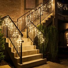 stairs decorated with christmas lights in front of a brick building