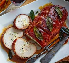 a white plate topped with meat covered in sauce